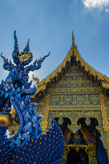 Fototapeta na wymiar Beautiful public Buddhist church at Wat Rong Sua Ten in Chiang Rai, Thailand. Wat Rong Suea Ten (Temple of Tigers Leaping over Channel) or the Blue Temple is above all its magnificent blue interior.