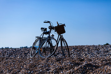 Bikes parked on the rocky beach. Sunny day with bike concept. Recreation and sport with bikes