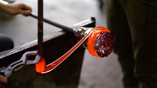 Molten glass being spun, shaped and cut to create a beautiful piece of art