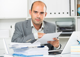 Portrait of male worker in the office sitting