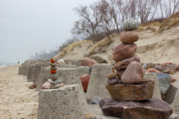 Stones pyramid on amber beach of Baltic sea