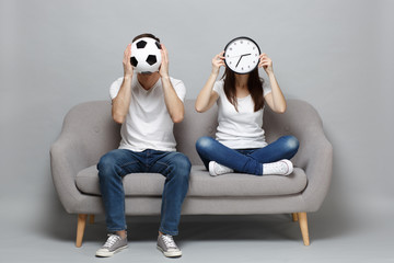 Couple woman man football fans in white t-shirt cheer up support favorite team covering face with...