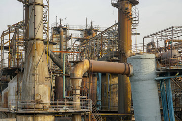 Old Factory metal structures. Industrial plant with old, rusty pipes and cooling tower for cooling water supply. Beijing, China.