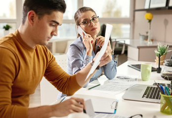 Young busy managers working in the office.