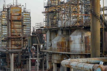 Old Factory metal structures. Industrial plant with old, rusty pipes and cooling tower for cooling water supply. Beijing, China.