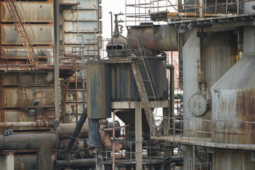 Old Factory metal structures. Industrial plant with old, rusty pipes and cooling tower for cooling water supply. Beijing, China.
