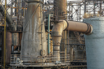 Old Factory metal structures. Industrial plant with old, rusty pipes and cooling tower for cooling water supply. Beijing, China.