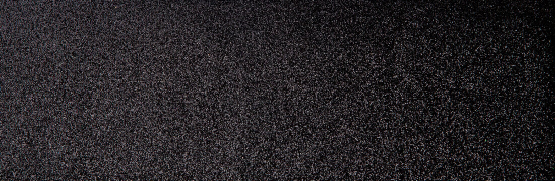 Silver sequins pattern. Sparkling sequins on black wool fabric as background