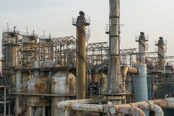 Old Factory metal structures. Industrial plant with old, rusty pipes and cooling tower for cooling water supply. Beijing, China.