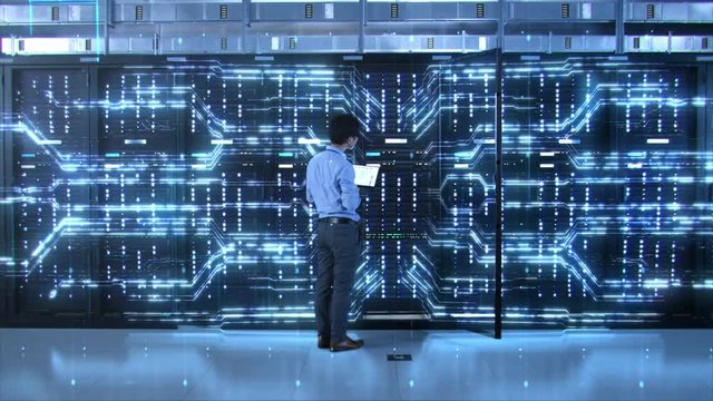 IT Specialist Standing In front of Server Racks with Laptop, He Activates Data Center with a Touch Gesture. 3D Animated Concept of Digitalization: Network of Lines Spreading Symmetrically. Zoom Out