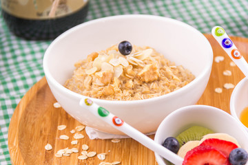 close-up oatmeal - healthy breakfast, on green tablecloth