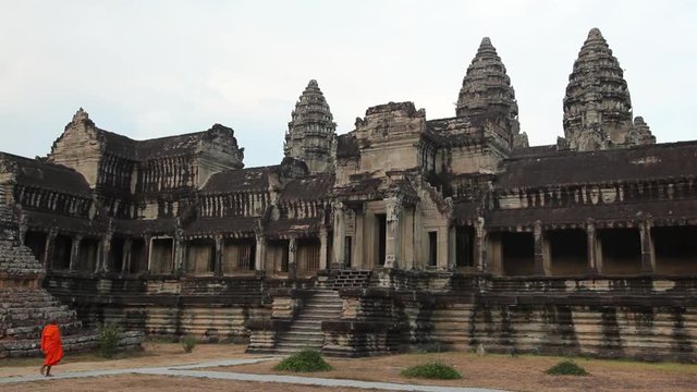 WS Buddhist monks walking in front of ancient temple / Angkor Wat, Siem Reap, Cambodia