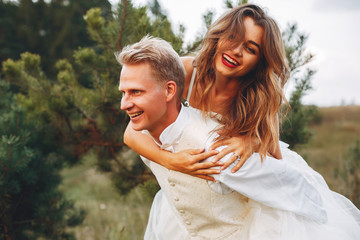 Beautiful wedding couple in a summer field