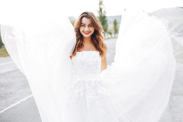 Beautiful bride walking in a summer field