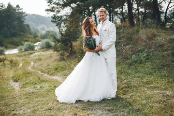 Beautiful wedding couple in a summer field