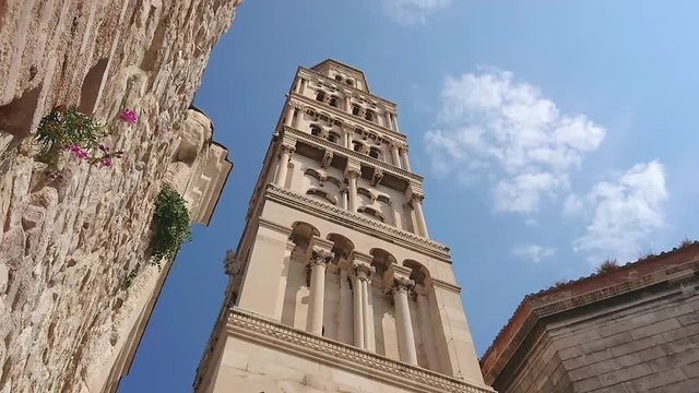 Panning to the Bell Tower of the Saint Domnius cathedral in Split, Croatia. Marble ancient roman architecture in city downtown center of Split, view from below. Mobile smart phone footage.
