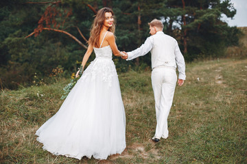 Beautiful wedding couple in a summer field