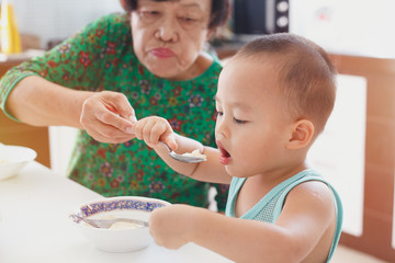 Toddler boy learning to  eat