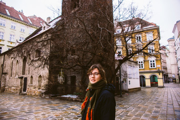 Fototapeta na wymiar Tourist woman posing smiling between the cold and wet neighborhoods of Budapest.