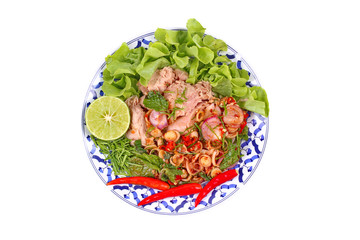 Isolated of spicy and sour mixed herb salad with tuna served .