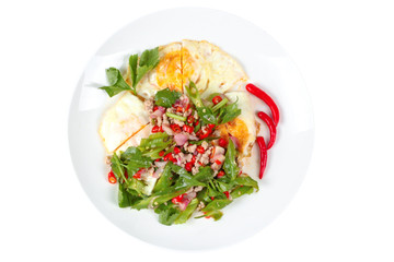 Isolated of spicy wing bean with pork topped fried egg.