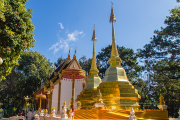 Naklejka premium Beautiful golden pagodas at Wat Phra That Doi Tung, Chiang Rai. Wat Phra That Doi Tung comprises of a twin Lanna-style stupas, one of which is believed to contain the left collarbone of Lord Buddha.
