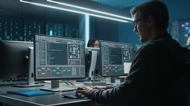Team of IT Programers Working on Desktop Computers in Data Center System Control Room. Team of Young Professionals Working In Software and Hardware Development, Doing Coding 