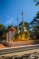 Naklejka premium Beautiful golden pagodas at Wat Phra That Doi Tung, Chiang Rai. Wat Phra That Doi Tung comprises of a twin Lanna-style stupas, one of which is believed to contain the left collarbone of Lord Buddha.