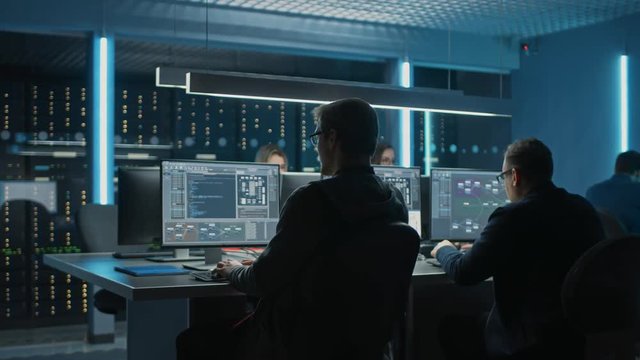Team of IT Programers Working on Desktop Computers in Data Center System Control Room. Team of Young Professionals Working In Software and Hardware Development, Doing Coding 