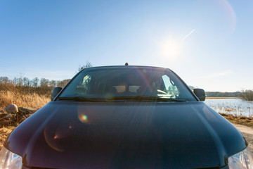 Fototapeta na wymiar black car hood on the background of bright sunny sky