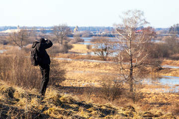 photographer on top of a hill in the background of a beautiful landscape