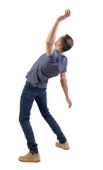 Back view man Balances waving his arms.