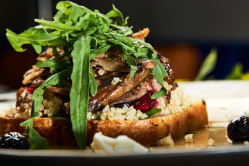  A plate with healthy breakfast, fresh toast with meat, brioche, beet chutney