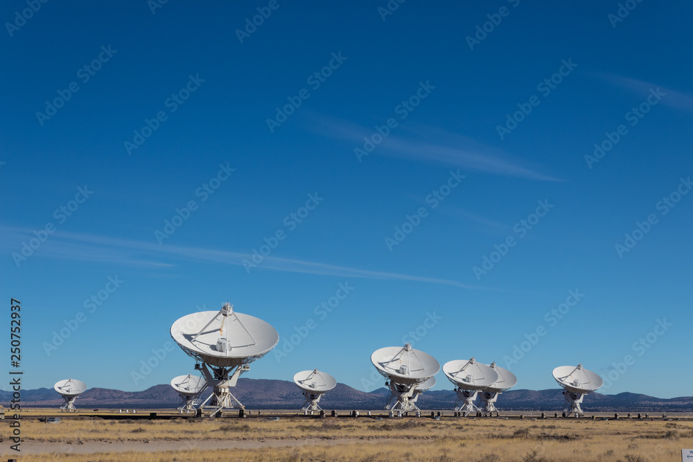 Canvas Prints very large array distant view of numerous dish antennas pointing toward a blue sky, science technolo