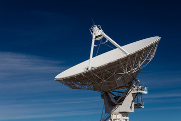 Very Large Array huge white radio satellite dish isolated against a dark blue sky, horizontal aspect