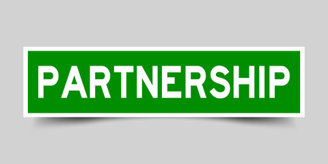 Square green sticker label in word partnership on gray background