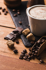 Black coffee with milk flatlay view on wooden background