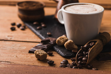 Black coffee with milk flatlay view on wooden background