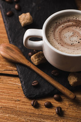 Black coffee with milk flatlay view on wooden background