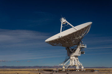 Very Large Array VLA radio antenna dish on pad in the New Mexico desert listening to the cosmos,...