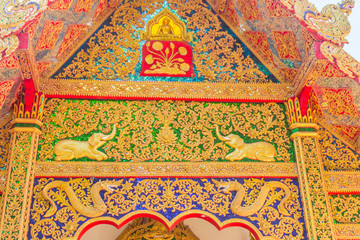 Beautiful golden craving on the entrance gable of the church at Wat Phra That Doi Tung, one of which is believed to contain the left collarbone of Lord Buddha.
