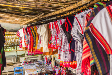 Beautiful traditional handmade clothes for sale to the tourist as the souvenir at the local market in hill tribe minority village at northern Thailand.