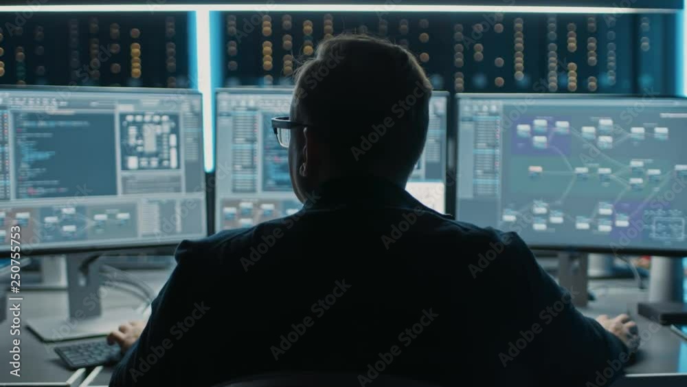 Fototapete Professional IT Programer Working in Data Center on Desktop Computer with Three Displays, Doing Development of Software and Hardware. Displays Show Blockchain, Data Network Architecture. Back View