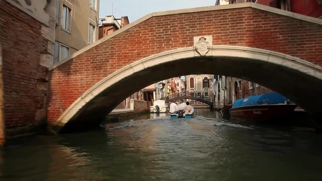 TS WS BOAT POV Travelling along narrow canal / Venice, Italy