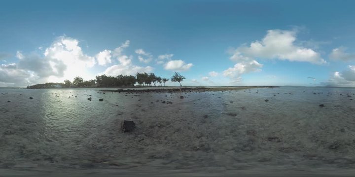360 VR video. Mauritius Island with houses and trees along the coast. View from shallow waters to the ocean and beach with black volcanic rocks