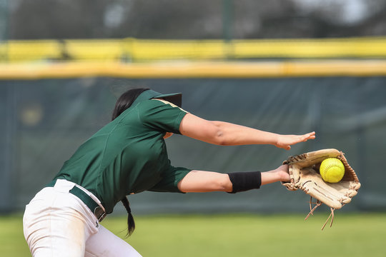 Girls in action playing in a softball game