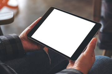 Mockup image of woman's hands holding black tablet pc with blank screen horizontally in cafe