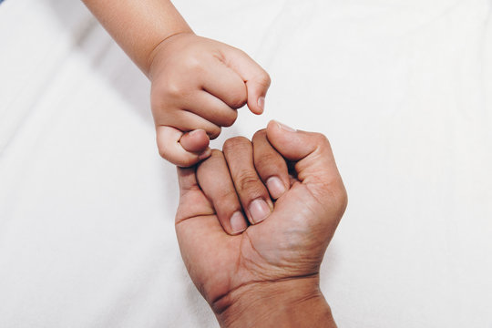 Closeup of kids hand into parents hands. Family concept
