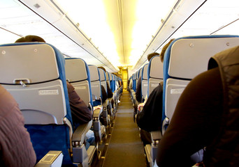 people sitting in the seat of an airplane