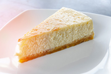 milk cake sweet food / piece of dessert delicious vanilla cake slice on white plate on the table background